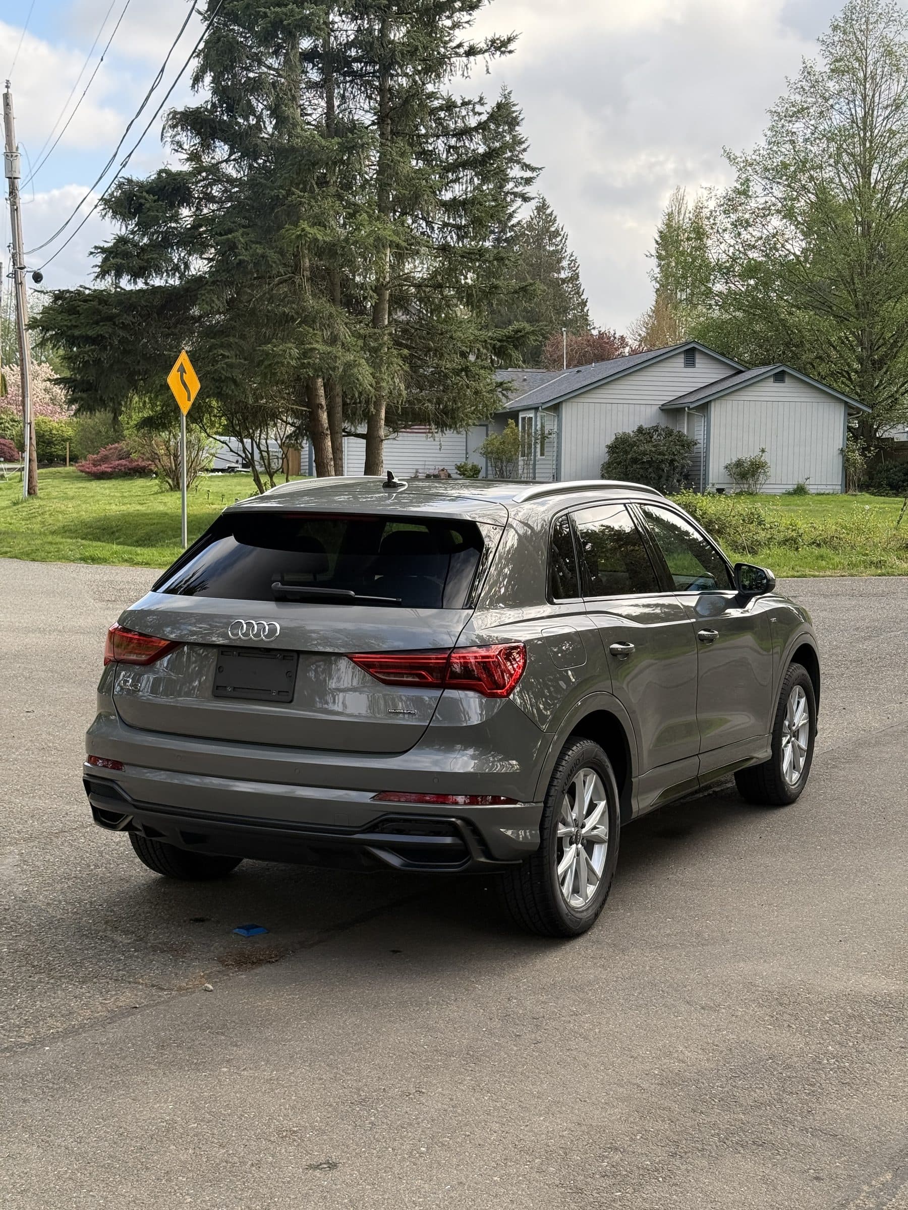 Rear three-quarter view of an Audi Q3 showing glossy, polished and coated paint