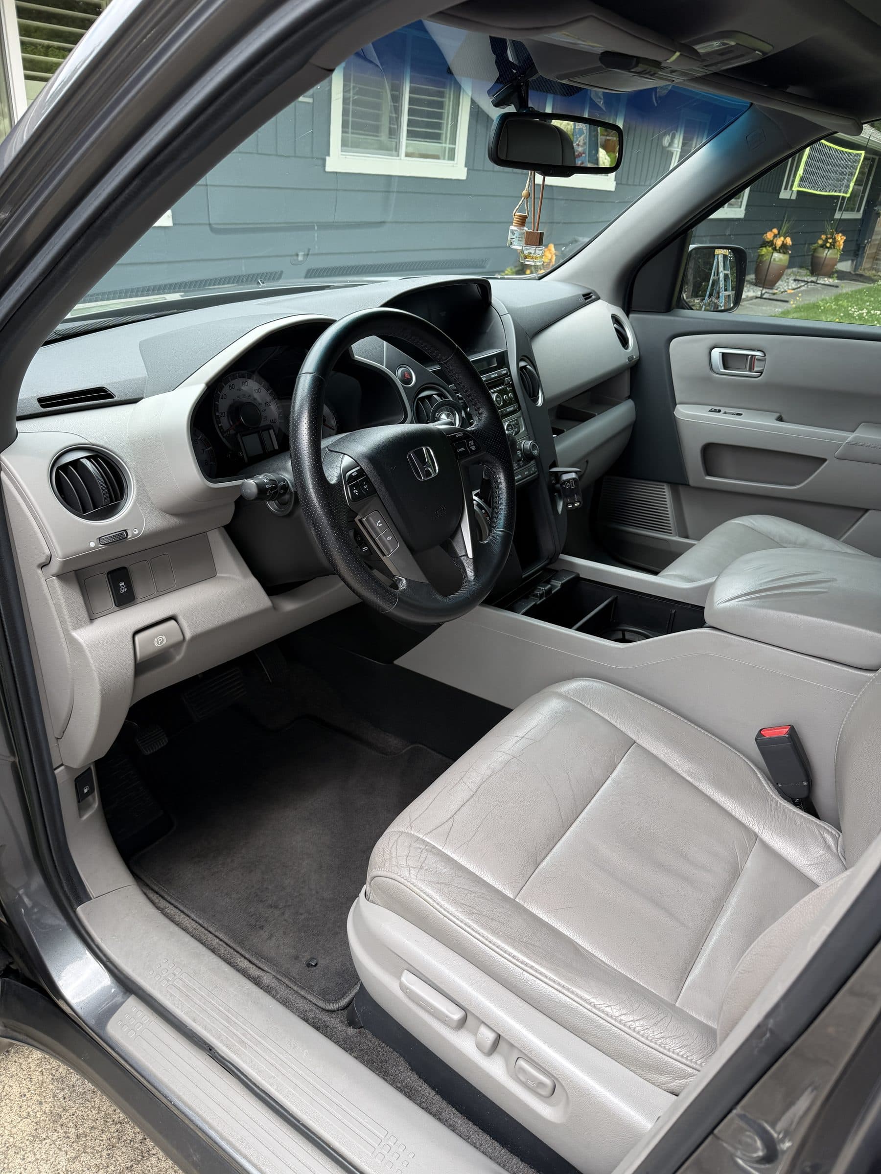 Honda Pilot interior with clean gray leather seats and carpets after an interior detail